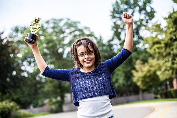 istock Young girl is holding a trophy 175533772