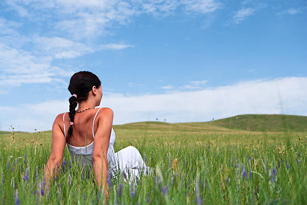 Young woman laying down on the meadow