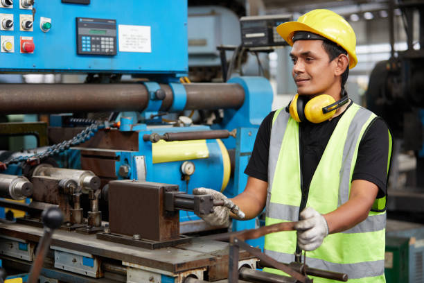 istock factory worker or technician checking and control old lathe machine in factory 1755344953