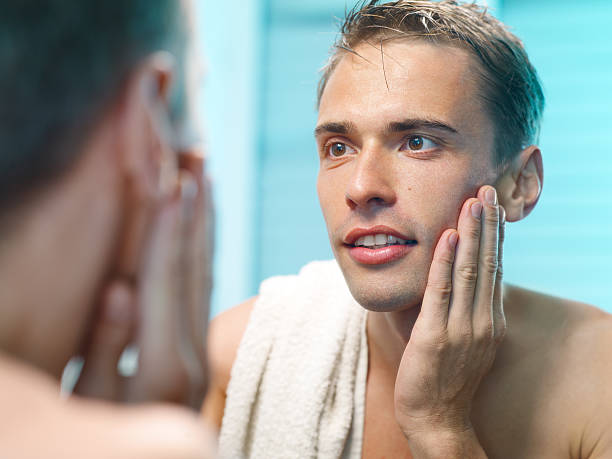 istock young man in front of the mirror after shaving 175534856