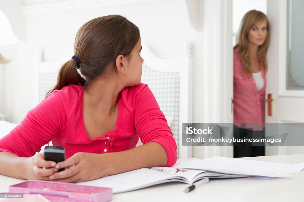 Mother Catches Daughter Using Phone When Meant To Be Studying Mother Catches Daughter Using Phone When Meant To Be Studying In Her Room Teenager Stock Photo