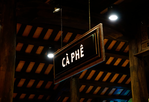 Coffee sign hanging from the ceiling in a coffee shop