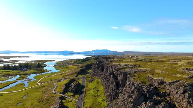 Aerial view of Thingvellir National Park, above the tectonic plates. Blue skies and greenery, Lake Bingvallavatn in the background