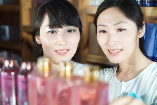 The east asian sisters enjoy buying cosmetics