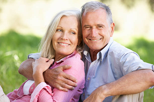 istock Senior Couple Relaxing In Sunny Summer Field 175535486