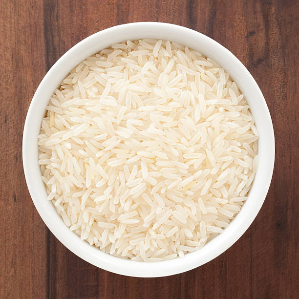 Jasmine rice Top view of white bowl full of jasmine rice jasmine rice stock pictures, royalty-free photos & images