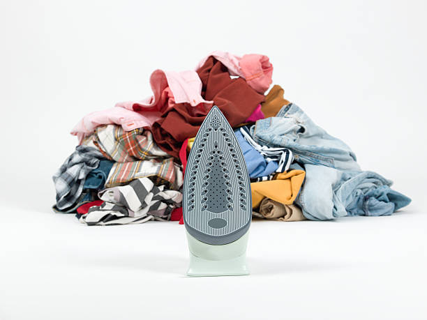 istock Iron with a pile of clothes 175536263