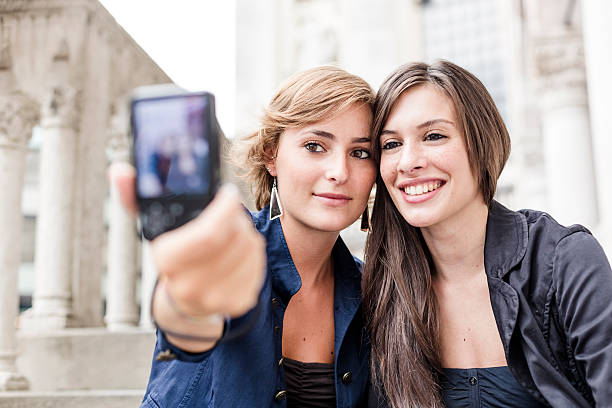 istock Best friends photographing themselves 175536626