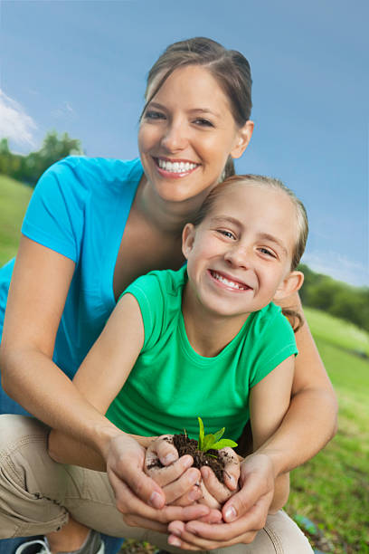 istock Mom & daughter in park with seedling plant; environmental issues 175536628