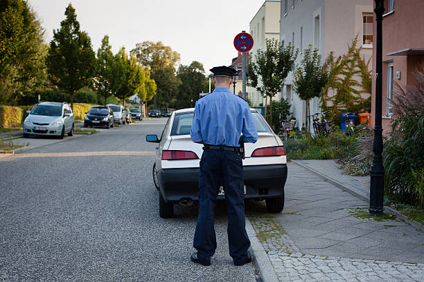 istock police officer writes a parking ticket 175537471