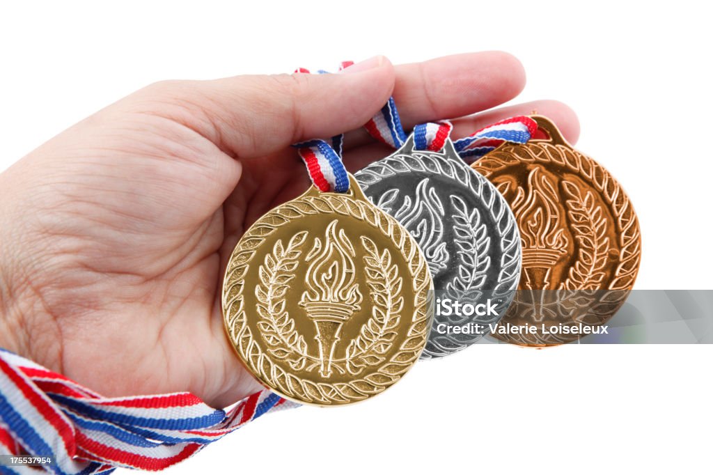 Três medalhas em mãos - Foto de stock de Dedo humano royalty-free