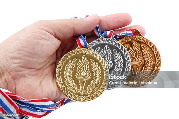 Foto de Três Medalhas Em Mãos e mais fotos de stock de Dedo humano - Dedo humano, Esporte, Figura para recortar