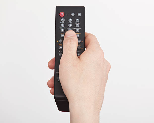 man hand holding remote control man hand holding remote control remote control stock pictures, royalty-free photos & images