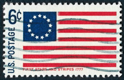 Cancelled Stamp From The United States Featuring The First American Flag From 1777.