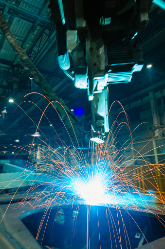 Welding Sparks  from robot  in manufacturing with blur focus, used is background