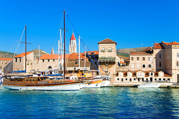 Trogir, Croatia - September 21, 2024: Scenic Trogir old town view from Kamerlengo Fortress, moored big-sized luxury motor yachts at promenade pier