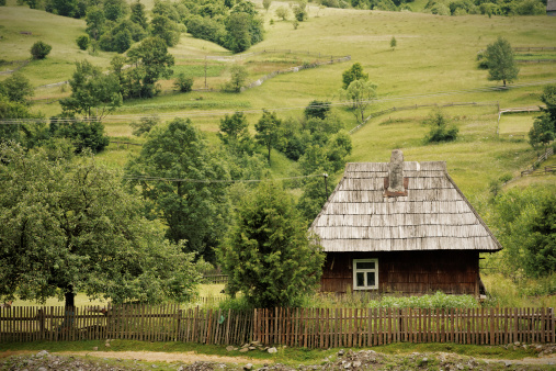 View of a traditional Russian wooden house on the territory of the Izborsk fortress on a sunny summer day, Izborsk, Pechersk district, Pskov region, Russia