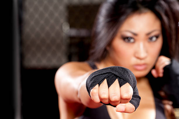 istock Fierce woman boxer in self defense posture 175539131