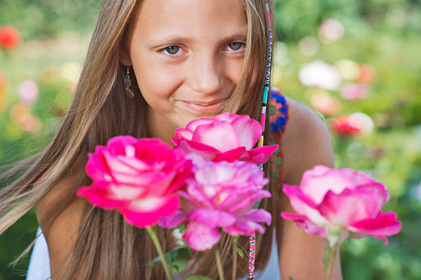Portrait of a little girl in the garden with flowers.