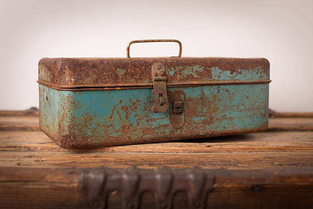 istock Rusted Antique Toolbox, Sitting on Wood Trunk 175539751