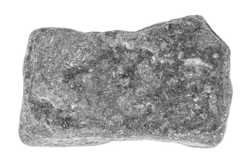 Grey stone isolated on white. Focus is front to back.