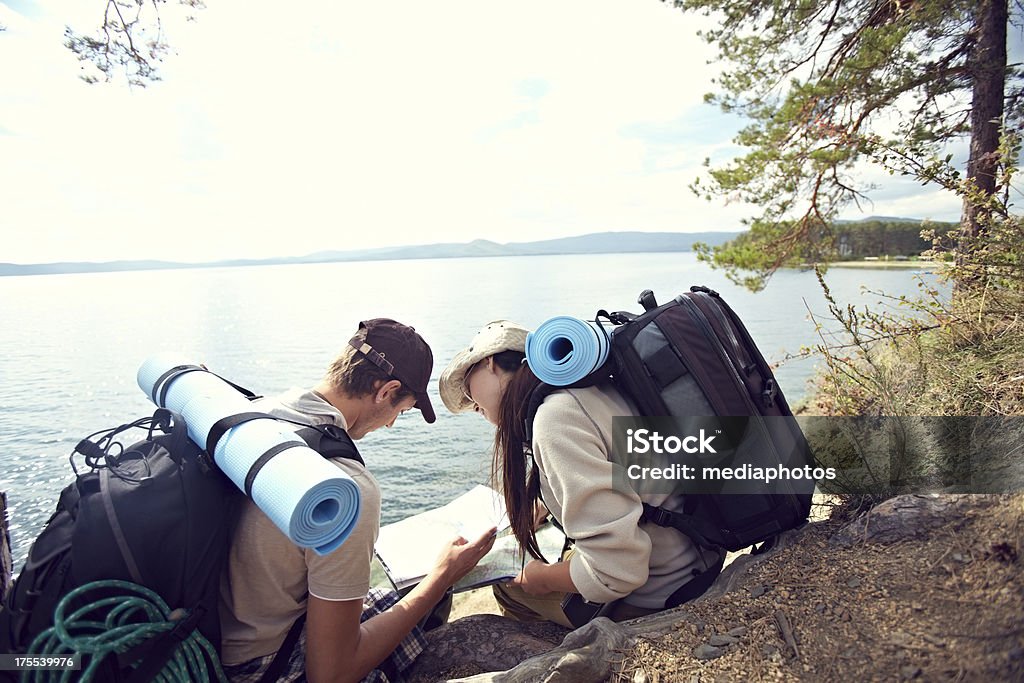 Hikers looking at map Happy young couple looking for directions on the map 20-24 Years Stock Photo