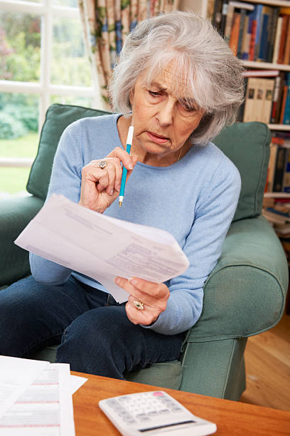istock Senior Woman Going Through Bills And Looking Worried 175540367