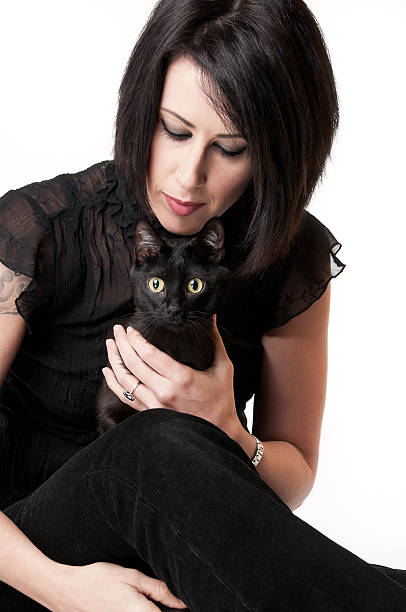 istock Beautiful Woman Holding a Black Cat 175540480