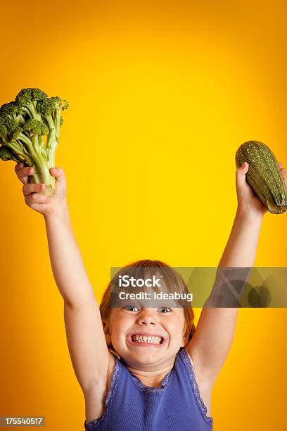 Excited Smiling Girl Holding Up Broccoli And Zucchini Stock Photo - Download Image Now