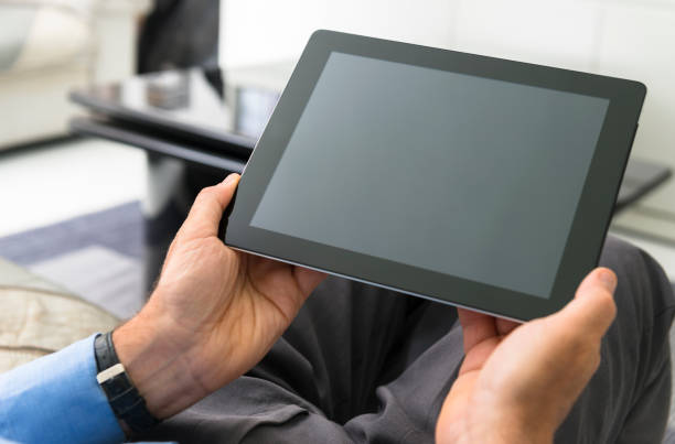 istock Man holding a contemporar digital tablet at home 175540868