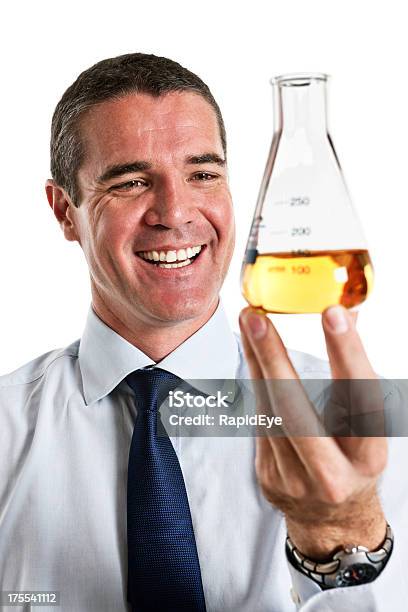 That Looks Good Smiling Man With Yellow Fluid In Flask Stock Photo - Download Image Now