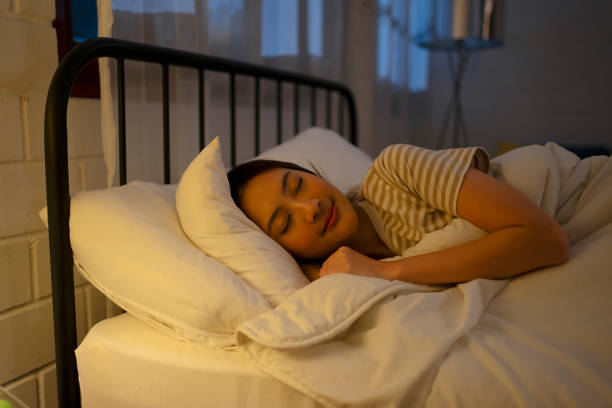 istock A woman sleeping at night. 1755414805