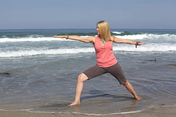 istock Woman Doing Yoga at the Beach Warrior Position 175541538