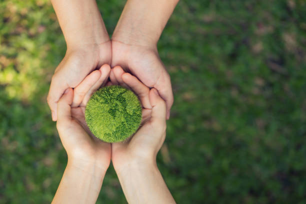 istock Environment Earth Day In the hands holding green earth. Saving the environment, and environmentally sustainable. Save Earth. Concept of the Environment World Earth Day. Net Zero.Green Energy and ESG. 1755415867