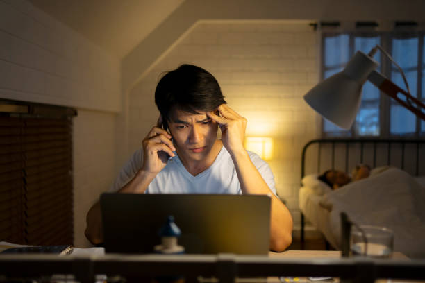 istock A man is working late at night. 1755416415