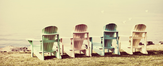 Adirondack chairs on the beach. Toned image