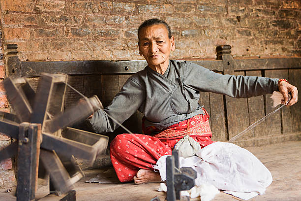 istock Nepali woman spinning the wool 175541781