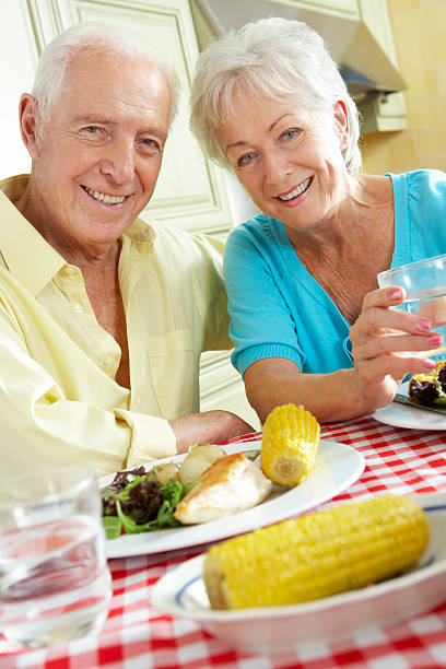 istock Senior Couple Eating Meal Together In Kitchen 175542108
