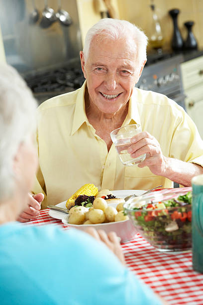istock Senior Couple Eating Meal Together In Kitchen 175542109