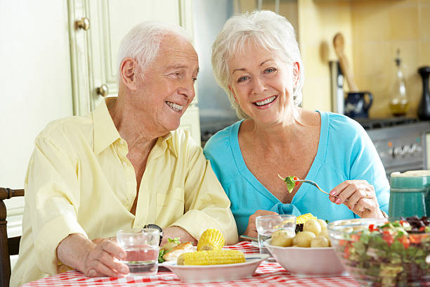 istock Senior Couple Eating Meal Together In Kitchen 175542239
