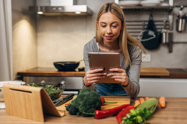 istock woman prepares food in kitchen 1755422896