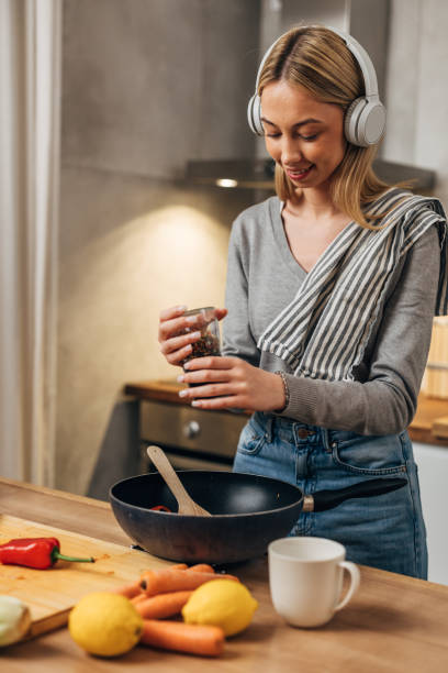 istock woman prepares food in kitchen 1755422920