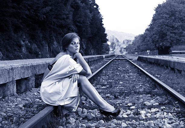 istock Attractive long haired brunette at railway station 175542303