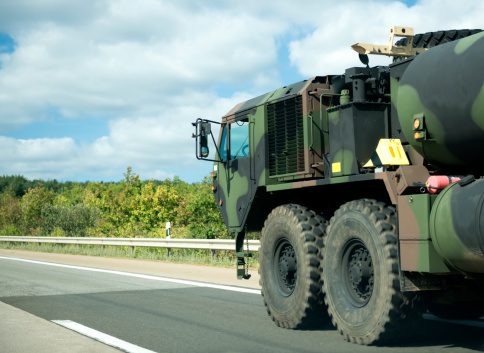 Detail shot on a military vehicle on a german highway. Some motion blur.