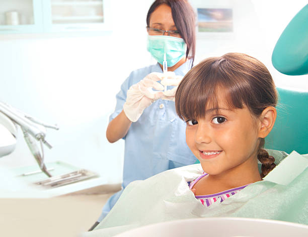 istock Young girl getting an injection from dentist 175542563