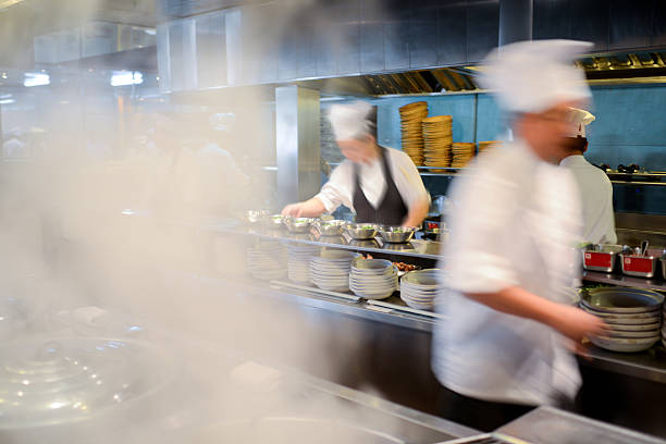 Many Busy Chefs Working In Kitchen - XXXLarge Many busy chefs are working in a big restaurant kitchen indoors restaurant hotel work tool stock pictures, royalty-free photos & images