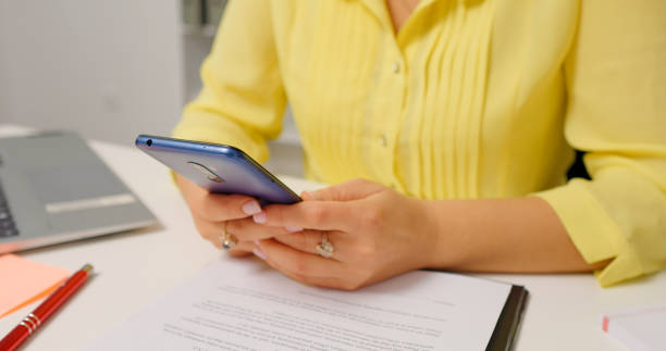 istock Female hands scrolling smart phone surfing internet in home office. 1755437464