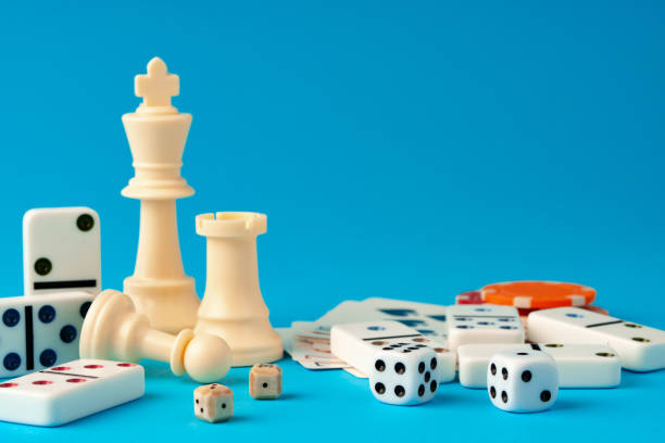 istock Items for playing chess, poker and domino on blue background studio shot 1755440732