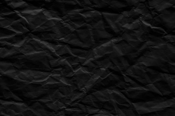 istock Crumpled black paper texture background. Wrinkled paper surface. 1755442883