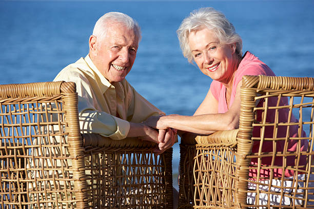 istock Senior Couple Sitting In Chairs Relaxing On Beach 175544303